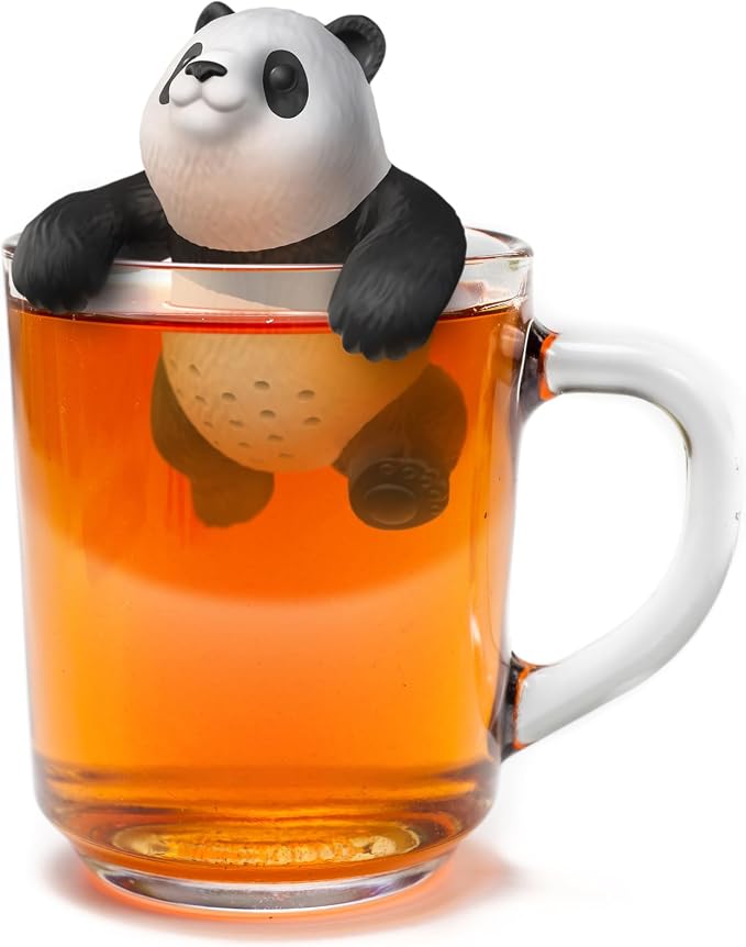 Panda-shaped tea infuser in a glass of tea on a white background
