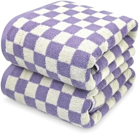 Two folded towels stacked on a white background, featuring a purple and off-white checkered pattern.
