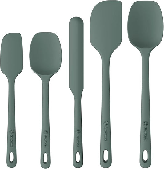 Set of five black silicone spatulas on a white background