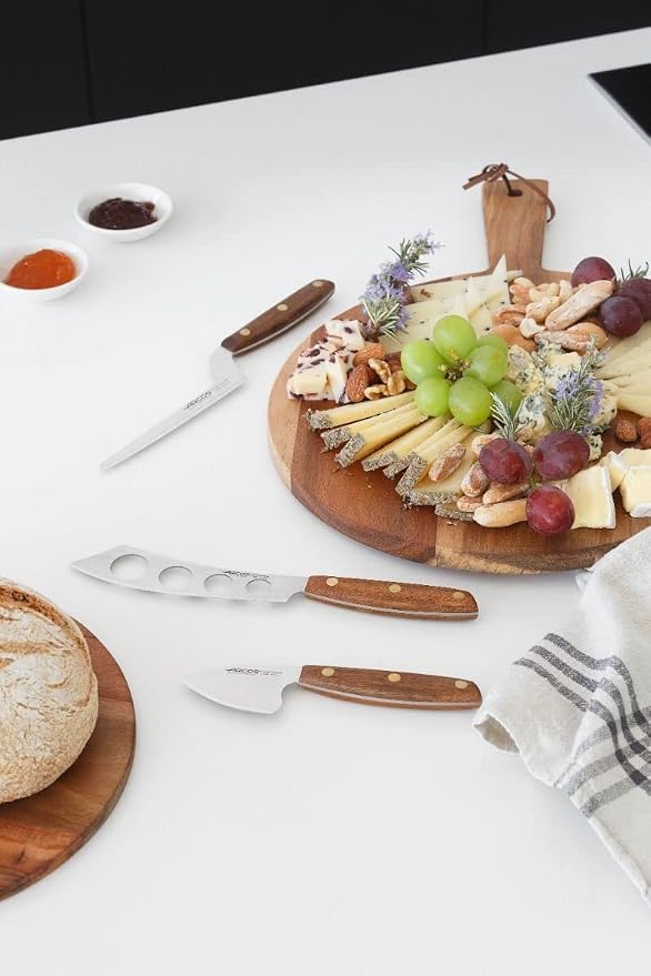 Arcos Cheese Knife set 3 pieces. Nitrum Stainless Steel. Very useful set for irregular pieces of hard cheeses, soft cheeses and creamy cheeses. Handle 100% Ovengkol wood Series Nordika. Color Brown.