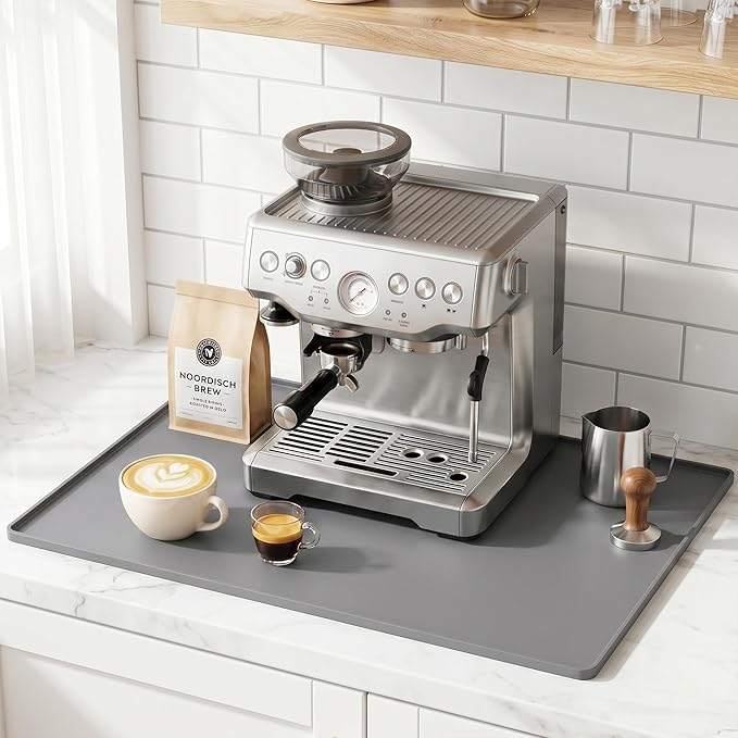 Espresso machine on a kitchen counter with coffee and a bag of coffee beans.