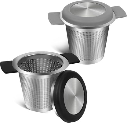 Two stainless steel tea infusers on a white background