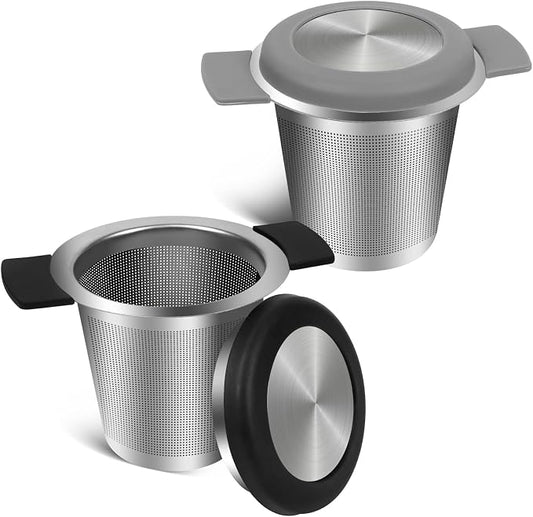 Two stainless steel tea infusers on a white background