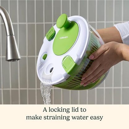Green and white kitchen strainer with a locking lid being used to strain water, set against a tiled wall background.