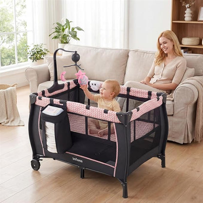 INFANS 3 in 1 Pack and Play, Portable Travel Baby Bassinet with Detachable Mattress, Changing Table, Foldable Playpen with Carry Bag, 2 Wheels (Pink Stripes)