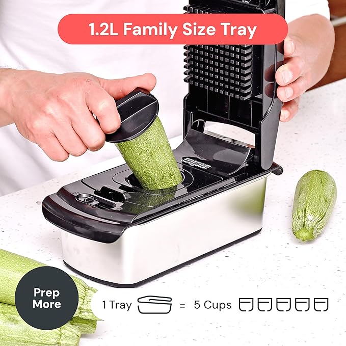 Veggie slicer with a 1.2L family size tray being used to slice a zucchini.