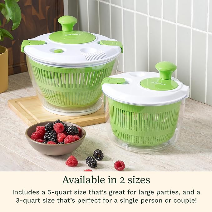 Two green salad spinners on a kitchen counter with a bowl of berries.