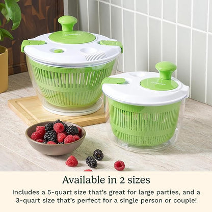 Two green salad spinners on a kitchen counter with a bowl of berries.