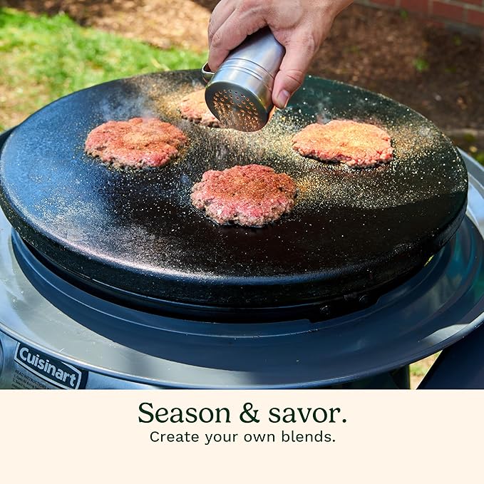 Person seasoning burgers on a Cuisinart grill outdoors